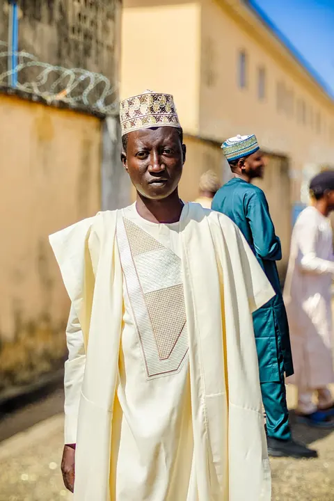 A man in a cream babban riga with a tonal embroidered chest panel