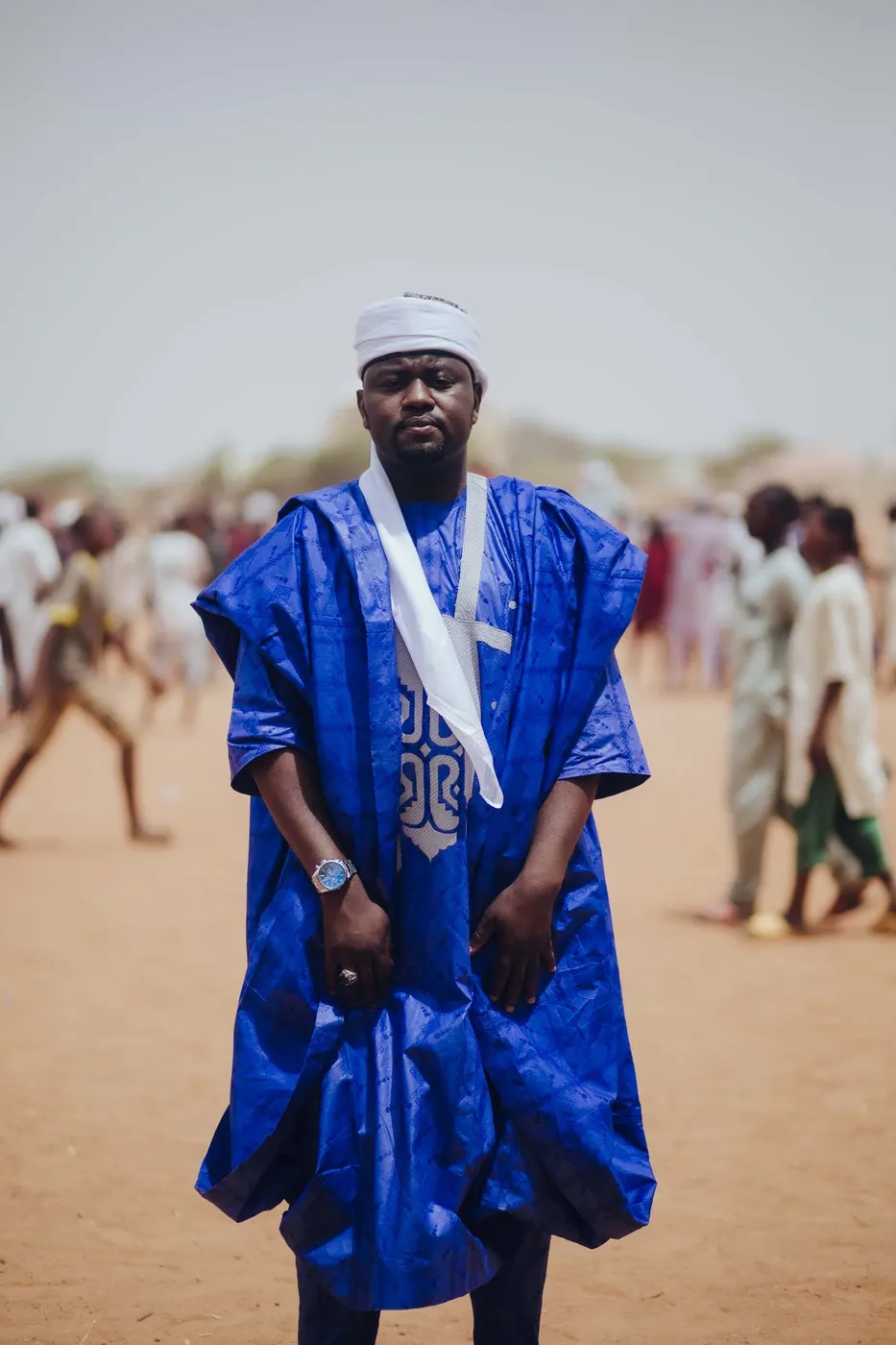 A man in a royal blue babban riga with tonal embroidery down the chest